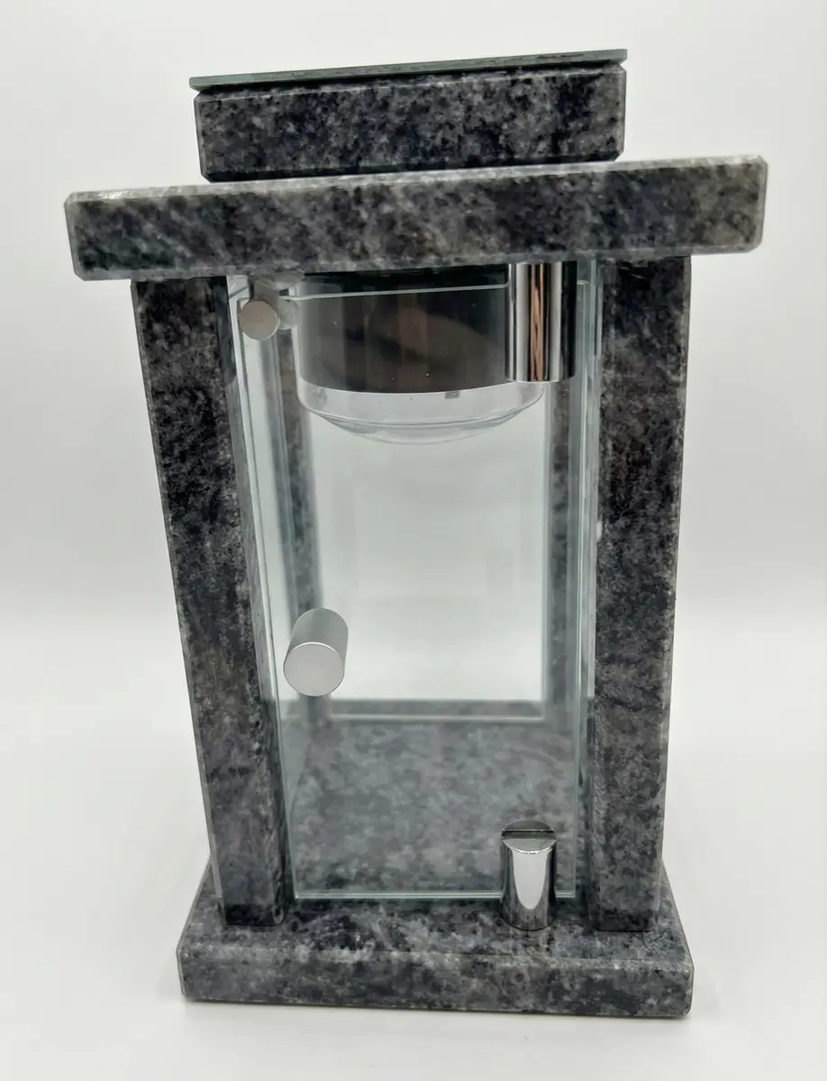 Black granite memorial lantern with brushed metal trims and front-opening glass door.