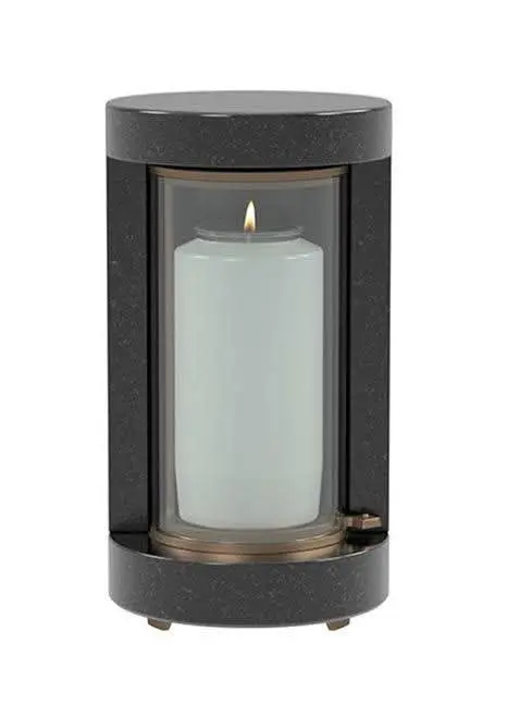 Modern black granite cylindrical memorial lantern with clear glass and a lit candle